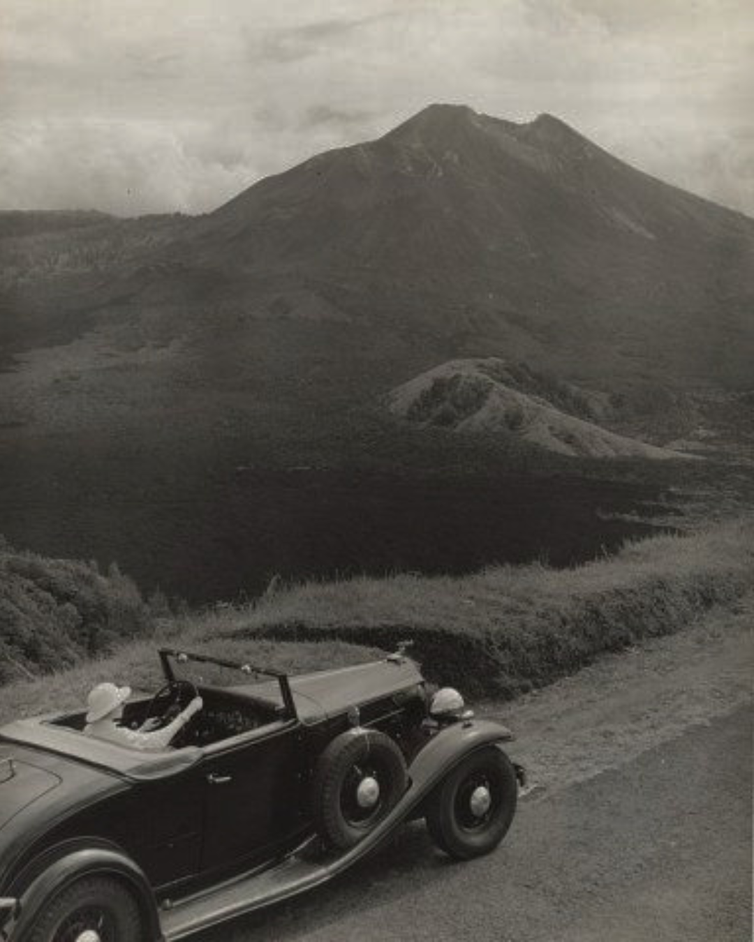 A vintage car on a mountain road